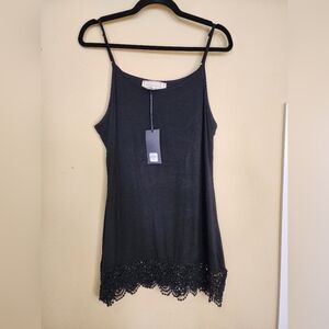 Sinuous black mini knit dress with lace hem